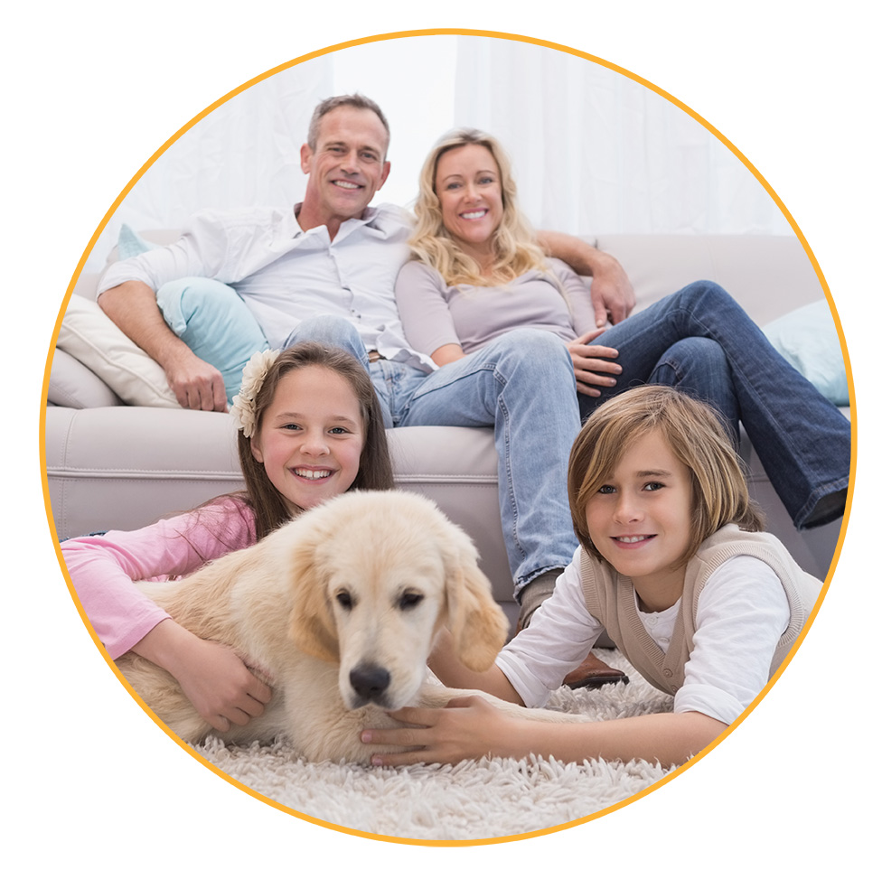A family sitting with their dog